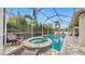 Screened pool and spa with lounge chairs and a spacious patio at 5230 Admiral Pointe Dr, Apollo Beach, FL 33572