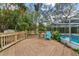 Wooden deck overlooking the pool and lush greenery at 6774 Treehaven Dr, Spring Hill, FL 34606