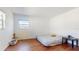 Bright bedroom featuring wood-look flooring and a large bed at 6915 Avenue Des Palais # 2B, South Pasadena, FL 33707