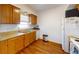 Clean kitchen featuring wood cabinets, laminate flooring, and a full suite of appliances at 6915 Avenue Des Palais # 2B, South Pasadena, FL 33707