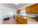 Kitchen with light wood cabinets, laminate flooring, and a double sink at 6915 Avenue Des Palais # 2B, South Pasadena, FL 33707