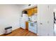 Simple kitchen with white appliances, wood cabinets and laminate flooring at 6915 Avenue Des Palais # 2B, South Pasadena, FL 33707