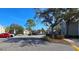 Ample parking lot with trees and landscaping at 7298 Ulmerton Rd # 202, Largo, FL 33771
