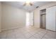 Bedroom with tile floors and a double door closet and ceiling fan at 7319 Sheepshead Dr, Hudson, FL 34667