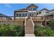 Two story home with deck, stairs, and lush landscaping at 861 Symphony Isles Blvd, Apollo Beach, FL 33572