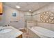 Bathroom with a large soaking tub and walk-in shower at 861 Symphony Isles Blvd, Apollo Beach, FL 33572