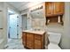 Basement bathroom with granite vanity, tiled shower, and wood cabinetry at 861 Symphony Isles Blvd, Apollo Beach, FL 33572