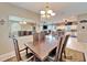 Elegant dining room with a large wood table and chandelier at 861 Symphony Isles Blvd, Apollo Beach, FL 33572