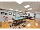 Basement game room with pool table, hardwood floors, and a seating area at 861 Symphony Isles Blvd, Apollo Beach, FL 33572