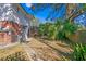 Large backyard with mature trees and a paved walkway at 930 15Th N Ave, St Petersburg, FL 33704