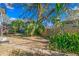 Spacious backyard with lush landscaping and a large tree at 930 15Th N Ave, St Petersburg, FL 33704