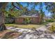 Brick home with large yard, mature trees, and sidewalk at 930 15Th N Ave, St Petersburg, FL 33704