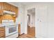 Kitchen with white stove, wood cabinets, and access to other rooms at 930 15Th N Ave, St Petersburg, FL 33704