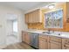 Kitchen with stainless steel dishwasher and wood cabinets at 930 15Th N Ave, St Petersburg, FL 33704