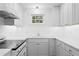 Modern white kitchen with updated appliances and a clean design at 930 15Th N Ave, St Petersburg, FL 33704