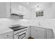 Modern white kitchen with updated appliances and a clean design at 930 15Th N Ave, St Petersburg, FL 33704