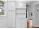 White kitchen cabinets, quartz countertops, and built-in shelving at 930 15Th N Ave, St Petersburg, FL 33704