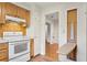 White stove and built-in ironing board in this galley kitchen at 930 15Th N Ave, St Petersburg, FL 33704