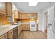 Galley kitchen with light wood cabinets and modern appliances at 930 15Th N Ave, St Petersburg, FL 33704