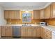 Bright kitchen featuring wood cabinets, stainless steel appliances, and a painted backsplash at 930 15Th N Ave, St Petersburg, FL 33704
