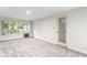 Living room featuring grey carpet, large window, and door at 930 15Th N Ave, St Petersburg, FL 33704