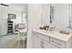 Clean and modern bathroom featuring quartz counters and a doorway to a bedroom at 949 Signet Dr, Apollo Beach, FL 33572