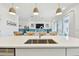 Bright kitchen island with sink overlooks the living room and dining area at 949 Signet Dr, Apollo Beach, FL 33572