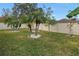 Landscaped backyard with palm trees and a grassy lawn at 10405 White Peacock Pl, Riverview, FL 33578