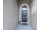 Elegant front door entry with arched window and neutral color palette at 10405 White Peacock Pl, Riverview, FL 33578