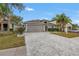 Two-story house with a gray garage door and paver driveway at 10405 White Peacock Pl, Riverview, FL 33578