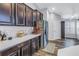 Modern kitchen with dark wood cabinets and stainless steel appliances at 10405 White Peacock Pl, Riverview, FL 33578