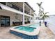 Resort-style pool and spa with outdoor seating at 105 Wimbledon Ct, Redington Shores, FL 33708