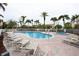 Community pool with lounge chairs and spa at 105 Wimbledon Ct, Redington Shores, FL 33708