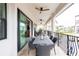 Outdoor dining area on balcony with seating for six at 105 Wimbledon Ct, Redington Shores, FL 33708