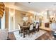 Open concept dining room with hardwood floors and a chandelier, adjacent to the kitchen at 105 Wimbledon Ct, Redington Shores, FL 33708