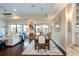 Elegant dining area with a large table and view into the adjacent kitchen at 105 Wimbledon Ct, Redington Shores, FL 33708