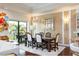 Formal dining room with a beautiful chandelier and access to a balcony at 105 Wimbledon Ct, Redington Shores, FL 33708