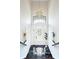 Bright entryway with a white door, marble floors, and a chandelier at 105 Wimbledon Ct, Redington Shores, FL 33708