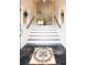 Elegant entryway with a grand staircase and marble flooring at 105 Wimbledon Ct, Redington Shores, FL 33708