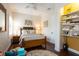 Cozy guest bedroom with a built-in shelving unit and an adjacent closet at 105 Wimbledon Ct, Redington Shores, FL 33708