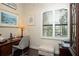 Bright home office features built-in shelving and window with plantation shutters at 105 Wimbledon Ct, Redington Shores, FL 33708