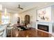 Living room with hardwood floors, fireplace, and comfortable seating at 105 Wimbledon Ct, Redington Shores, FL 33708