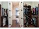 Spacious Primary closet with built-in shelving and access to the Primary bathroom at 105 Wimbledon Ct, Redington Shores, FL 33708