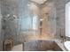 Large walk-in shower with glass enclosure and marble tile at 105 Wimbledon Ct, Redington Shores, FL 33708