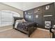 Bedroom with dark wood bed frame and accent wall at 11140 Irish Moss Ave, Riverview, FL 33569