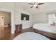 Spacious bedroom with hardwood floors and a large TV at 11140 Irish Moss Ave, Riverview, FL 33569