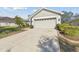 House exterior featuring a two-car garage and landscaping at 11140 Irish Moss Ave, Riverview, FL 33569