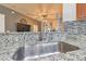 Stainless steel sink with modern faucet in a granite countertop kitchen at 11140 Irish Moss Ave, Riverview, FL 33569