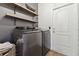 Laundry room with washer, dryer, and shelving at 11140 Irish Moss Ave, Riverview, FL 33569