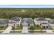 Aerial view of three houses on a tree-lined street at 12152 Ledbury Commons Dr, Gibsonton, FL 33534